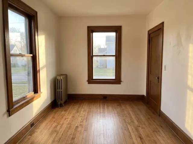 Freshly painted room with smooth plaster walls and wood trim in an older house
